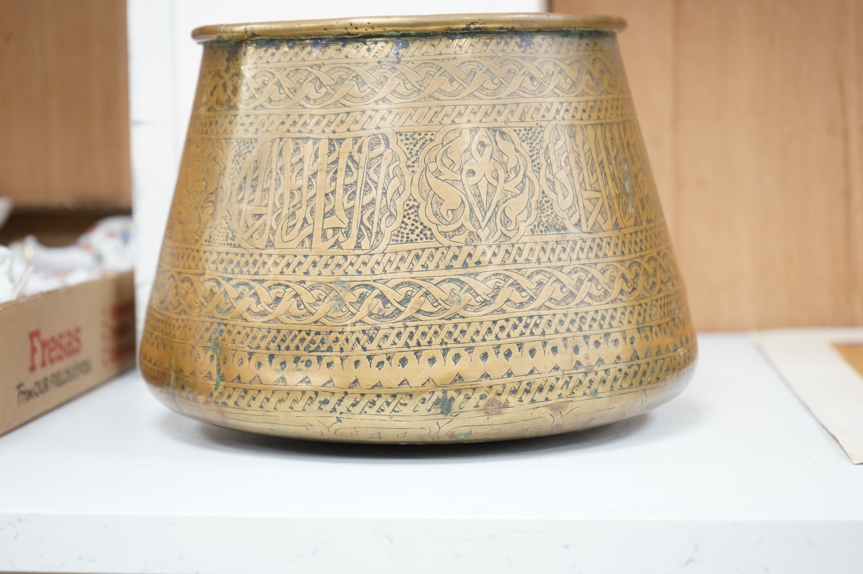 A Syrian Islamic copper vessel with detailed surface engraved pattern, 19cm high